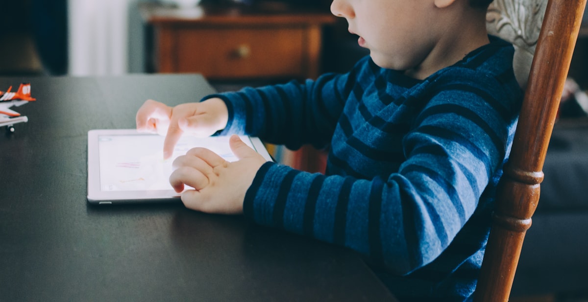 Child using a tablet screen