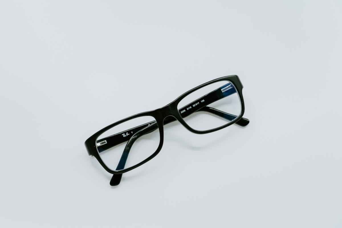 Reading glasses held up to text for presbyopia